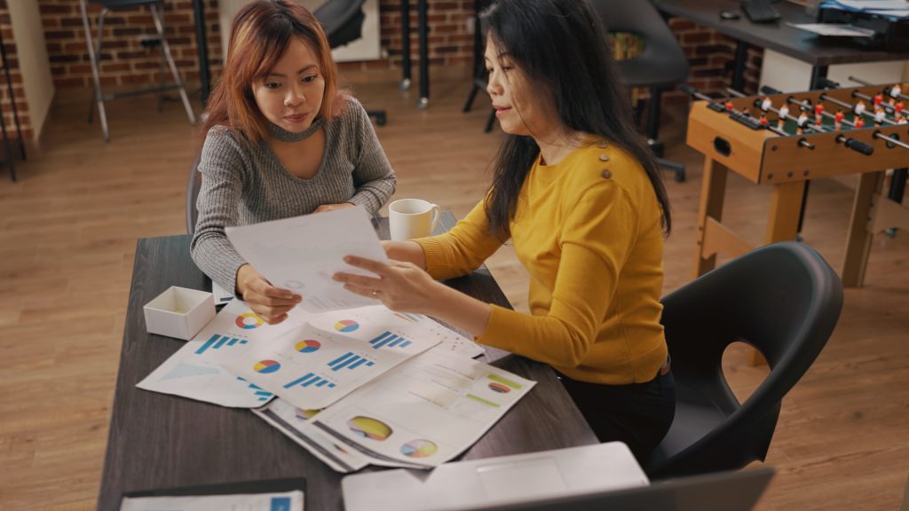 Colleagues looking at charts and graphs on documents