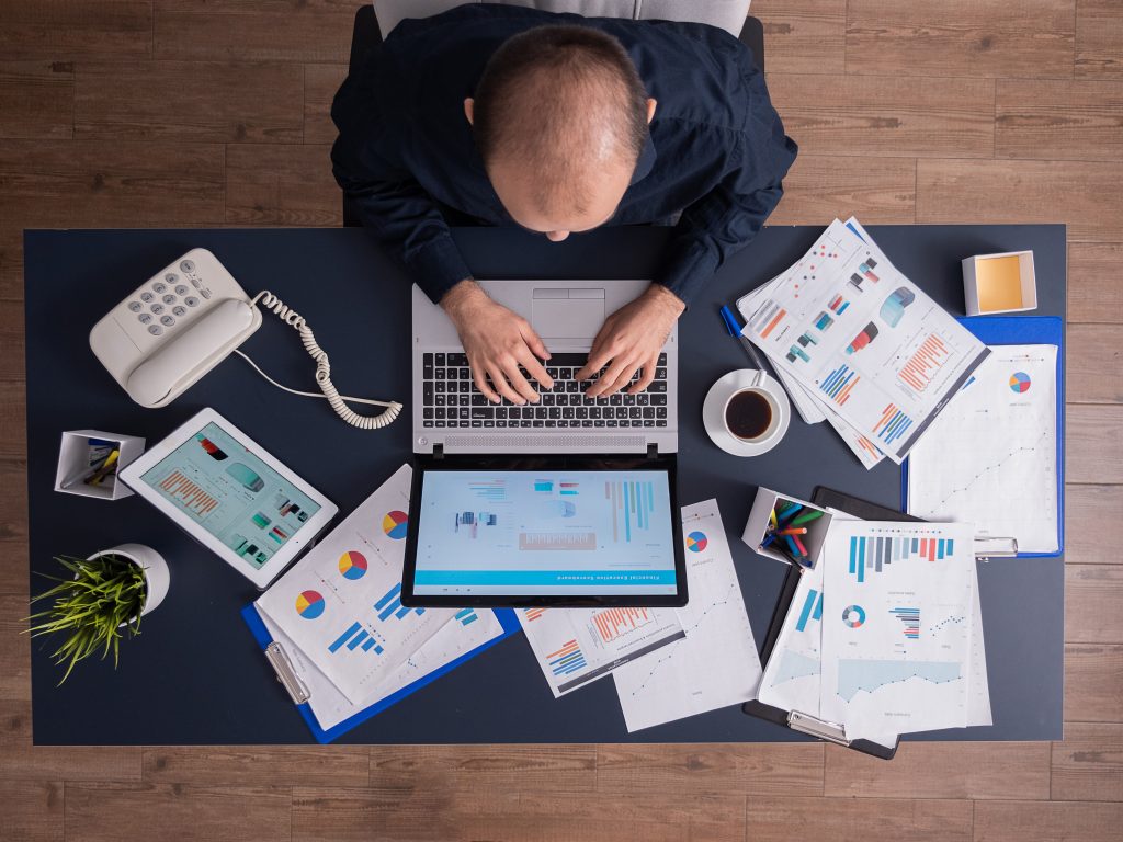Top view of business man in corporate office sitting at desk